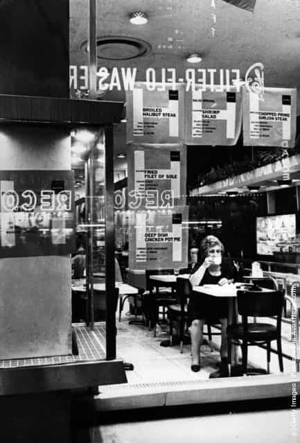 1968: A woman sitting in a Times Square cafeteria, New York