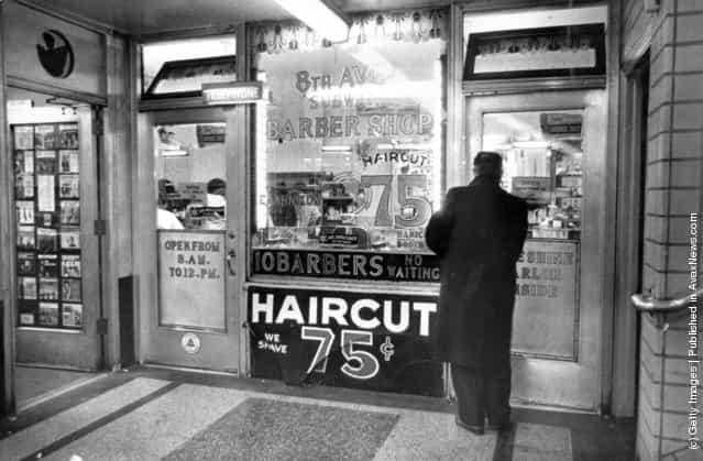 1969: A man entering a barber shop under Times Square, New York