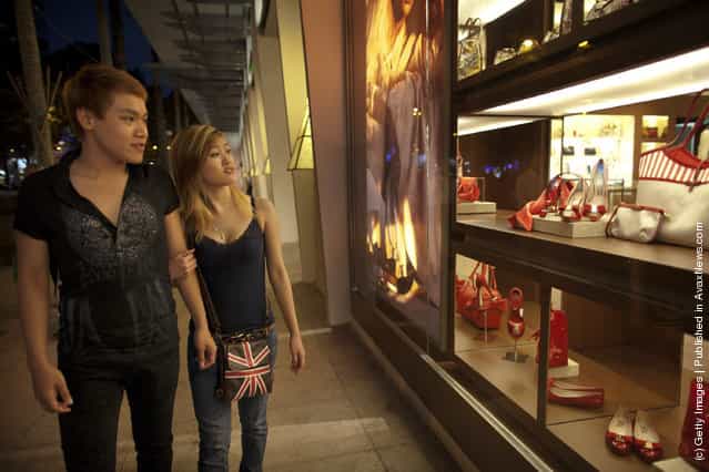 A Vietnamese couple gazes at the luxury items on sale at a brand new luxury mall