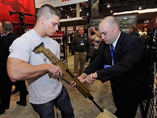 Ed Mazzeo (R) with Bushmaster Firearms shows Matteo Martini a semi-auotmatic Bushmaster Enhanced Adaptive Combat Rifle (ACR)