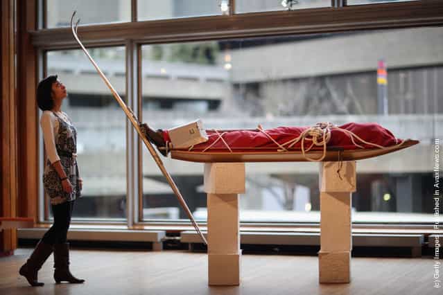 South Bank employee Lara Delaney stands besides a coffin in the shape of a skier