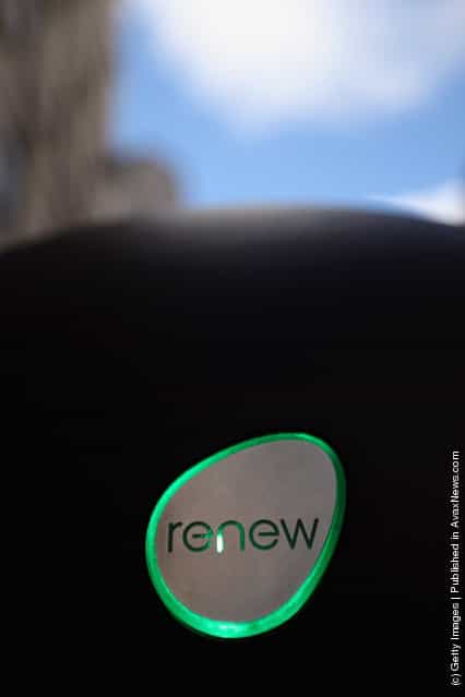People look at a newly installed Renew media point in the City of London