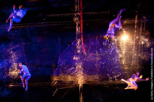 Artists preform on a pool suspended above the audience during the Fuerza Bruta dress rehearsal