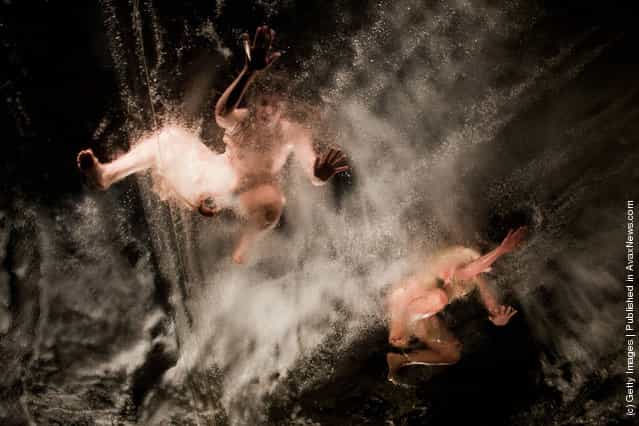 Artists preform on a pool suspended above the audience during the Fuerza Bruta dress rehearsal