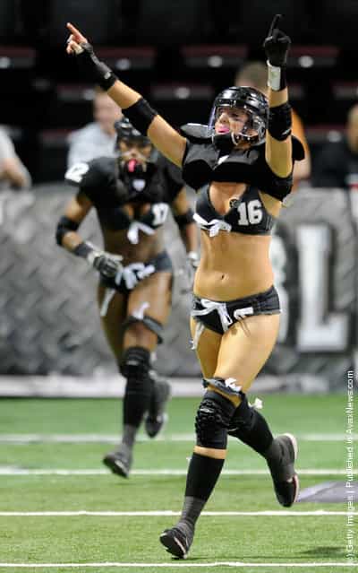 Natalie Jahnke #16 of the Los Angeles Temptation celebrates after the team scored a touchdown against the Philadelphia Passion during the Lingerie Football Leagues Lingerie Bowl IX