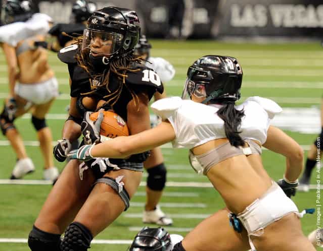 Amber Reed #10 of the Los Angeles Temptation runs for yardage against Shanae Thomas #17 of the Philadelphia Passion during the Lingerie Football Leagues Lingerie Bowl IX at the Orleans Arena