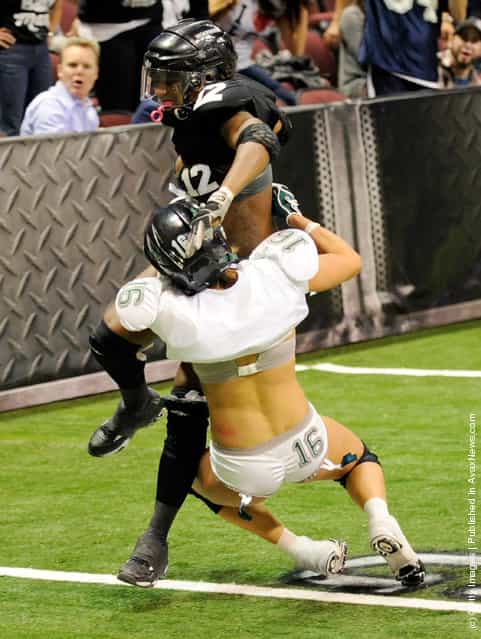 Danielle Harvey #12 of the Los Angeles Temptation scores a touchdown against Whitney Paronish #16 of the Philadelphia Passion during the Lingerie Football Leagues Lingerie Bowl IX at the Orleans Arena