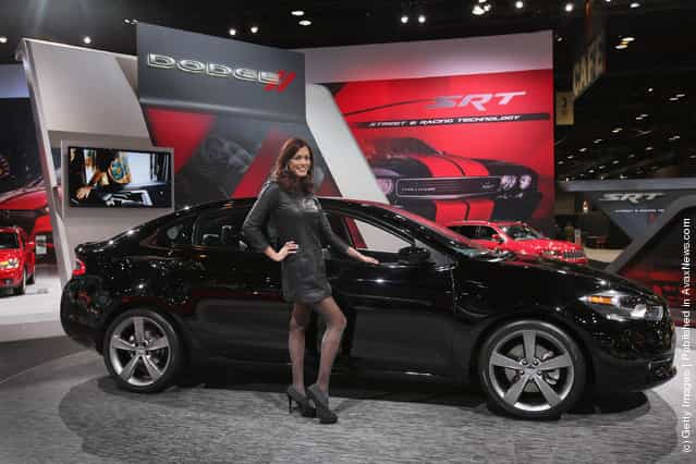 Julie Etheridge helps Dodge show off the new Dart during the media preview of the Chicago Auto Show
