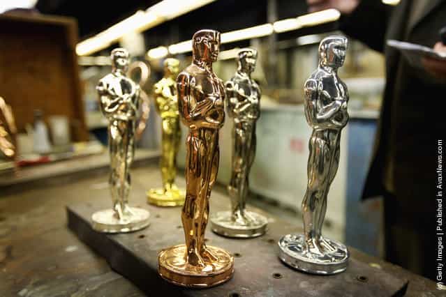 Oscar statuettes sit on a work bench prior to being assembled at R.S. Owens & Company