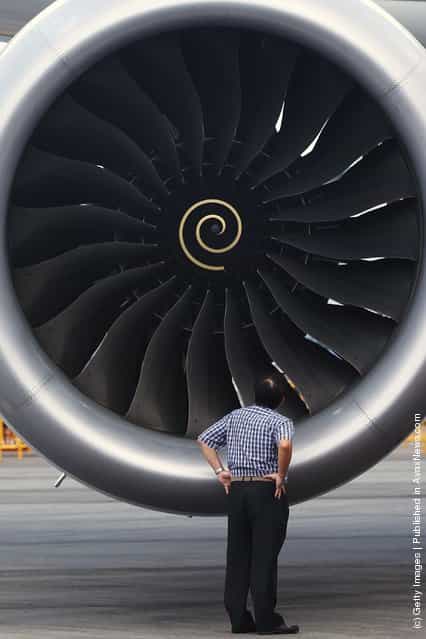 A man looks into the Rolls Royce engine of the Boeing 787 Dreamliner