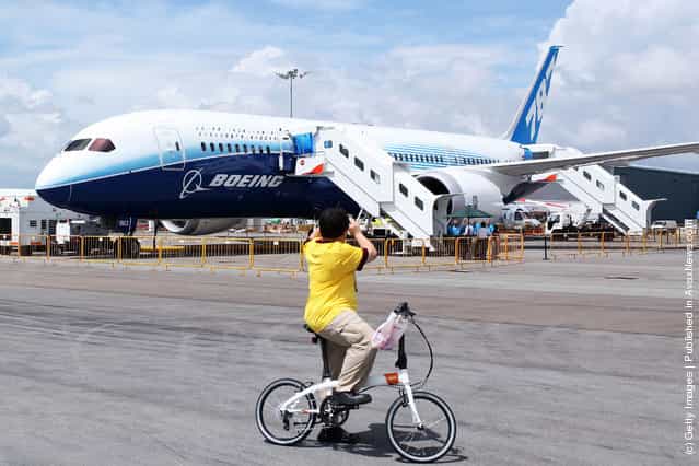 A man stops to take a photograph of the Boeing 787 Dreamliner