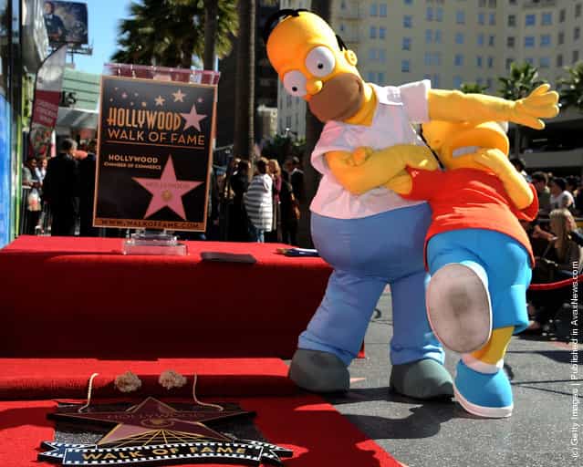Homer and Bart Simpson attend the ceremony honoring Matt Groening with a Star on The Hollywood Walk of Fameon