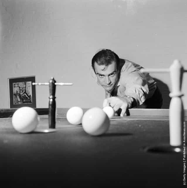 1962: Scottish actor Sean Connery, the new face of superspy James Bond, enjoys a game of bar billiards at his basement flat in Londons NW8