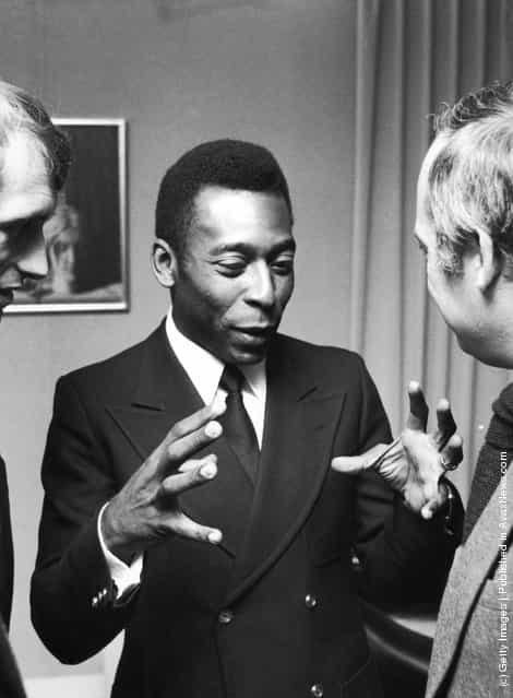 Brazilian footballer Pele talking to Belgian minister of culture H.F Van Aal, during a reception in Brussels, 26th March 1975