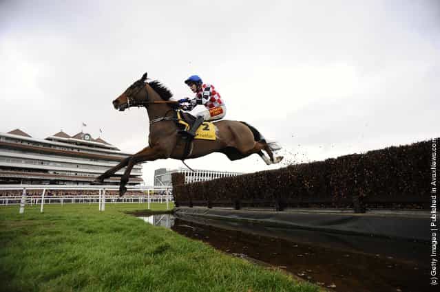 Tom Scudamore riding The Giant Bolster clear the water jump in The Betfair Denman Steeple Chase, at Newbury racecourse