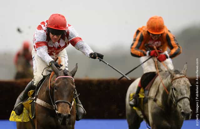 Barry Geraghty (L) riding Riverside Theatre clears the last to win The Betfair Ascot Steeple Chase from Medermit (R) at Ascot racecourse in Ascot, England