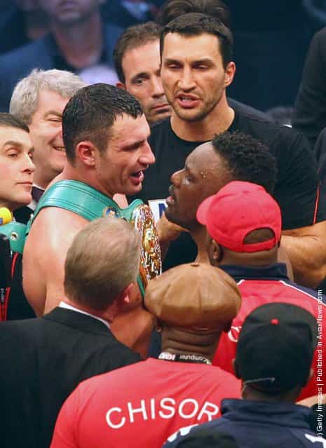 Vitali Klitschko (3rdL) of Ukraine discusses with Dereck Chisora of the UK after their WBC heavyweight World Championship title fight