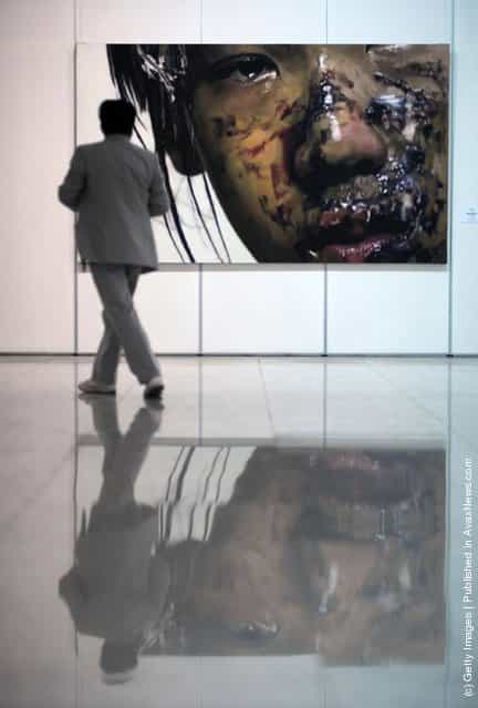 A visitor views the work entitled 'I am An Actor 1' by Chinese artist Li Haide