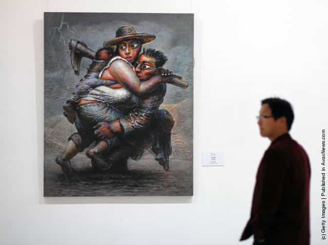 A visitor views the work entitled 'Cross the River' by Chinese artist Luo Zhongli