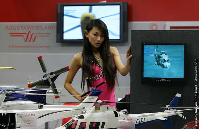 A Chinese model promotes a foreign helicopter company during the 11th Beijing Aviation Expo