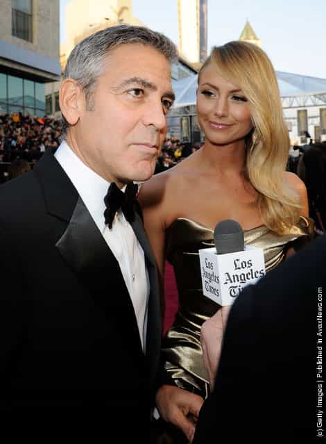 Actor George Clooney (L) and Stacy Keibler arrive at the 84th Annual Academy Awards held at the Hollywood & Highland Center
