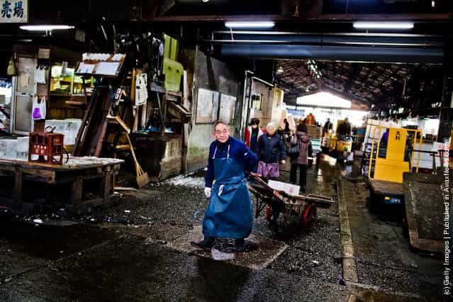 A workers wheels boxes used to store fish and other seafood goods, which will then be packed with ice at the Tsukiji fish market