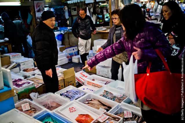 Customers point to a fish they would like to purchase at the Tsukiji fish market