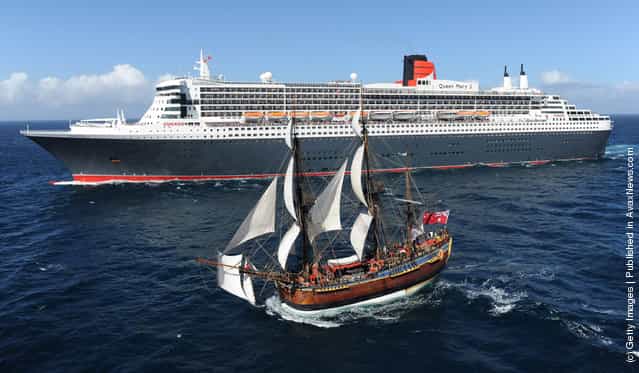 The Queen Mary 2 is saluted by the HMB Endeavour, the replica of Captain James Cooks ship off the coast of Victoria, Australia