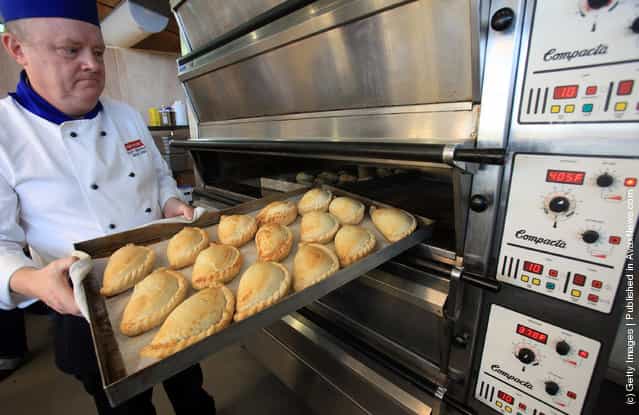 Head chef Tony Henshaw takes freshly baked pasties out of the oven at the World Cornish Pasty Championships at The Eden Project