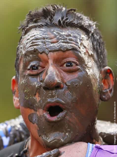 Sebastian Torallo reacts after crawling through the mud pit as he competes in The Tough Bloke Challenge