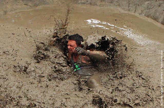 Predag Trajkvoc falls in the mud after swinging across the Piranha Pit as he competes in The Tough Bloke Challenge