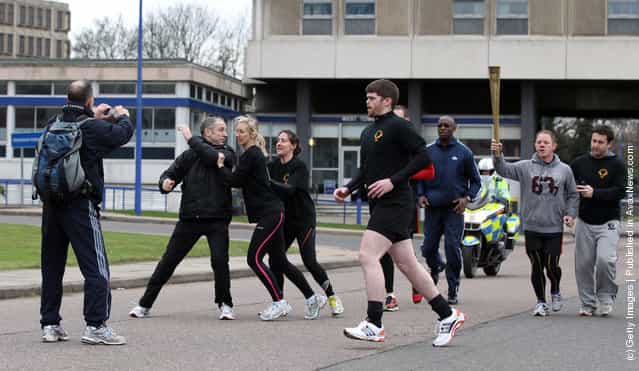 Men stage an attack during a training session for the Olympic Torch Security Team who will be protecting the torch bearers and Olympic flame during the torch relays progress through the UK, at the Metropolitan Police Training School