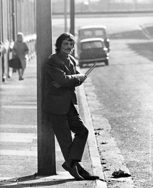 Tommy Moore, an early drummer for The Beatles, in a street near the River Mersey holding drumsticks on March 3, 1970