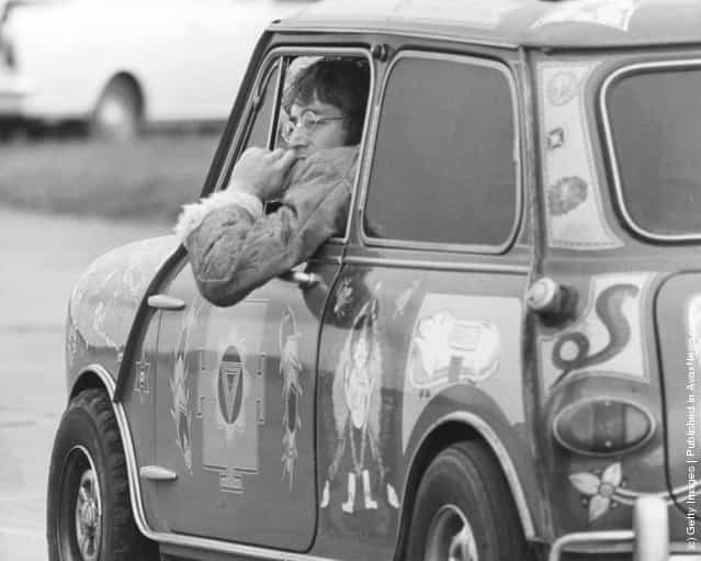 Singer and songwriter John Lennon (1940 - 1980) of the Beatles, in a psychedelic Radford Mini de Ville owned by George Harrison at West Malling Airfield, Kent, 7th November 1967. The Beatles are at the Aerodrome for work on their TV film Magical Mystery Tour