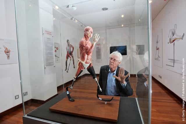 Artist Richard Neave admires the sculpture Sprinting that he created with Denise Smith in London