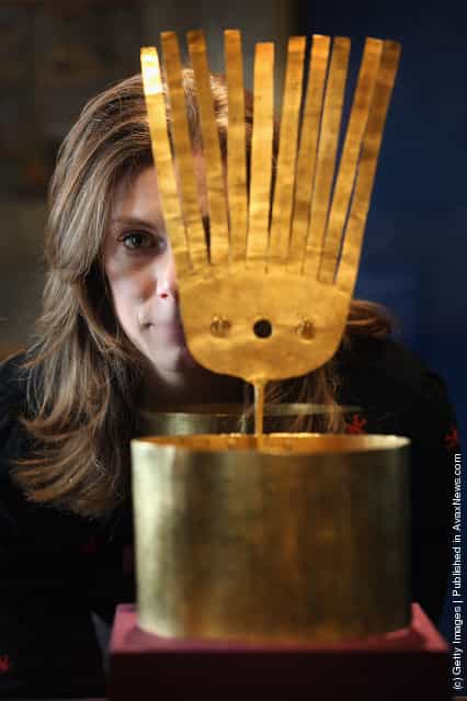 Alice Ross views a gold crown which was presented to Queen Victoria, part of the Royal Collection on display at the Queens Gallery