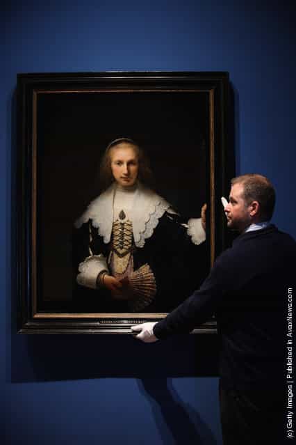 Stephen Webster, Exhibition co-ordinator, stands next to the painting Agatha Bas by Rembrandt, part of the Royal Collection