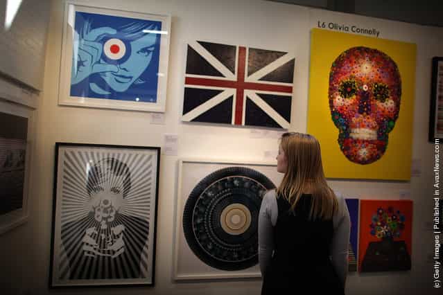A visitor to The Affordable Art Fair looks at paintings on March 15, 2012 in London