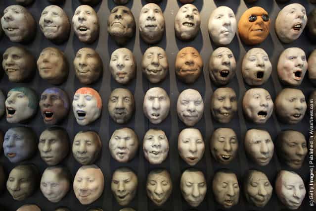 Pottery heads by artist Johan Thunell are displayed at The Affordable Art Fair
