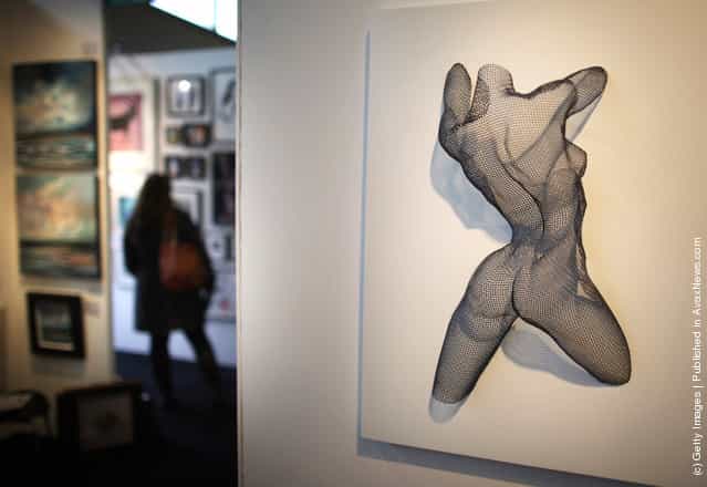 A mild steel mesh sculpture entitled Earth Dance by artist Nikki Taylor is displayed at The Affordable Art Fair