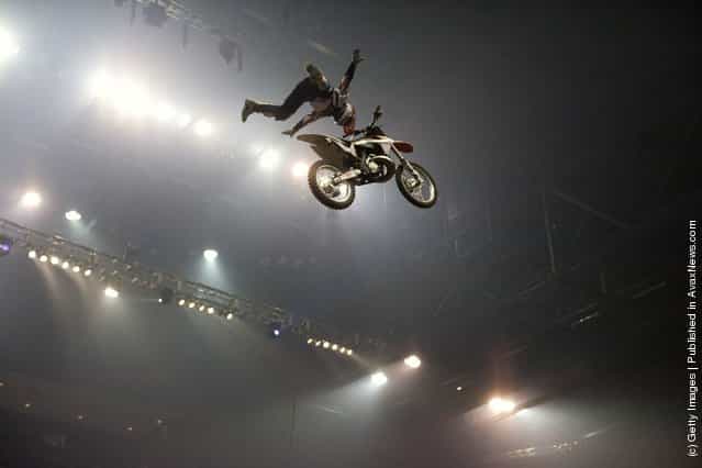 A motocross acrobat races at the Night of the Jumps freestyle motocross acrobatics at O2 arena