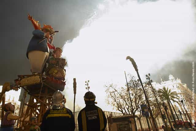 Firemen look on Combustible Ninot caricatures prepared to burn during the last day of the Fallas festival on March 19, 2012 in Valencia, Spain