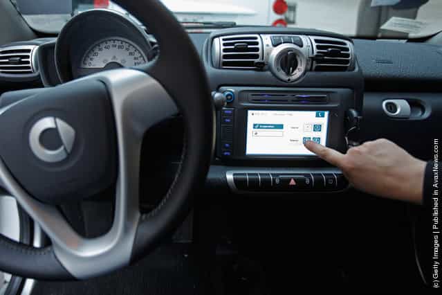 A car2go empoloyee demonstrates how members use the built-in touchscreen to access the car during a press preview