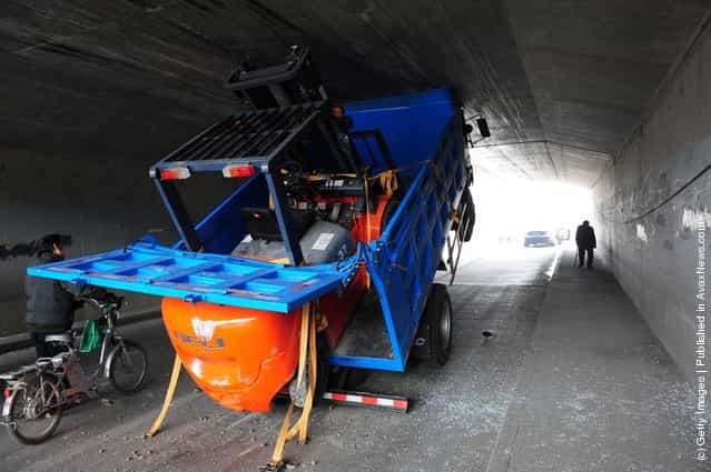 A truck becomes wedged in a tunnel due to carrying a high load at Shi Ba Li Dian Bridge on the East Fourth Ring Road in Beijing, China