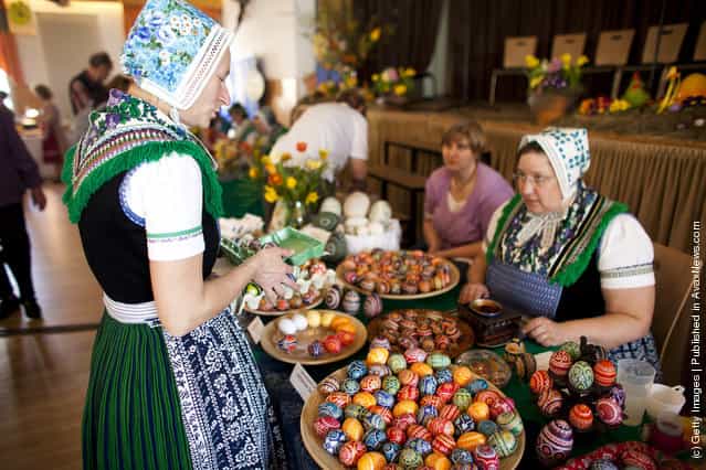 Women, wearing a traditional Lusatian sorbian folk dress, talk at the annual Sorbian Easter egg market