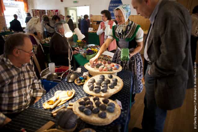  Sylvia Panoscha (C), wearing a traditional Lusatian sorbian folk dress, arranges eggs at the annual traditional Sorbian Easter egg market