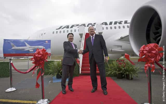 President and CEO of Japan Airlines Yoshiharu Ueki, left, shakes hands with Boeing Commercial Airplanes President Jim Albaugh after cutting the ribbon to celebrate the first delivery 787 to Japan Airlines at the Paine Field in Everett, Washington