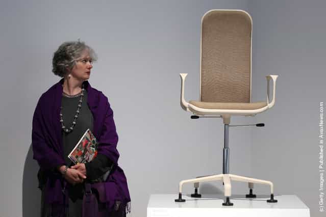 A woman looks at a 60s chair on display at the Victoria and Albert museums new major exhibition