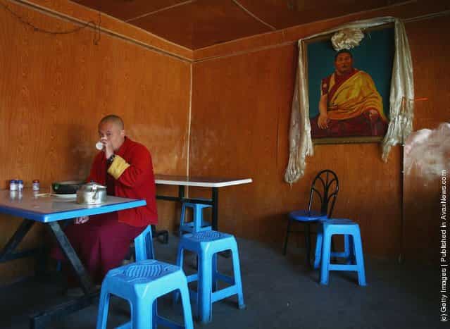 A lama dines in a restaurant at the Serthar Wuming Buddhist Study Institute