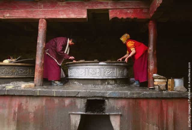 Nuns clean the huge pots used to cook food at the Serthar Wuming Buddhist Study Institute